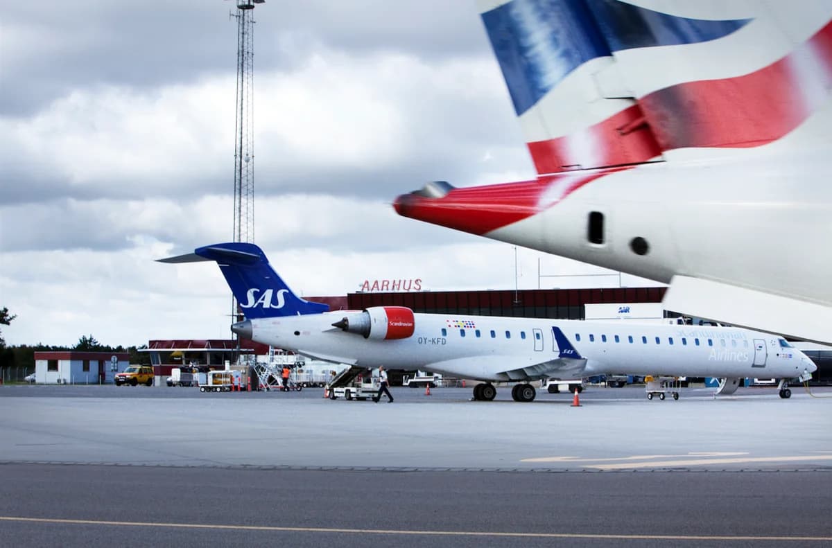 Exterior view of Aarhus Airport with parked airplanes on the tarmac.