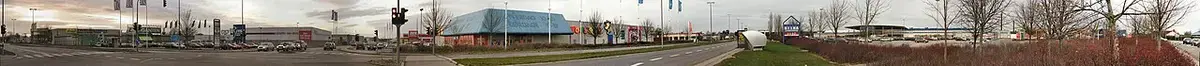 panoramic view of a large shopping center with multiple stores and parking