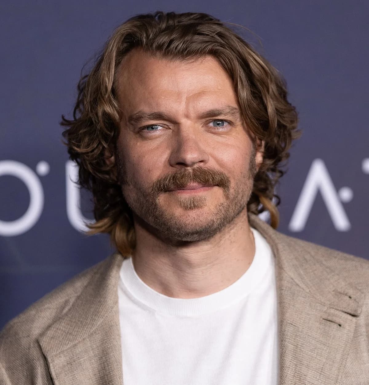 Pilou Asbæk posing at a Foundation season 3 press event.