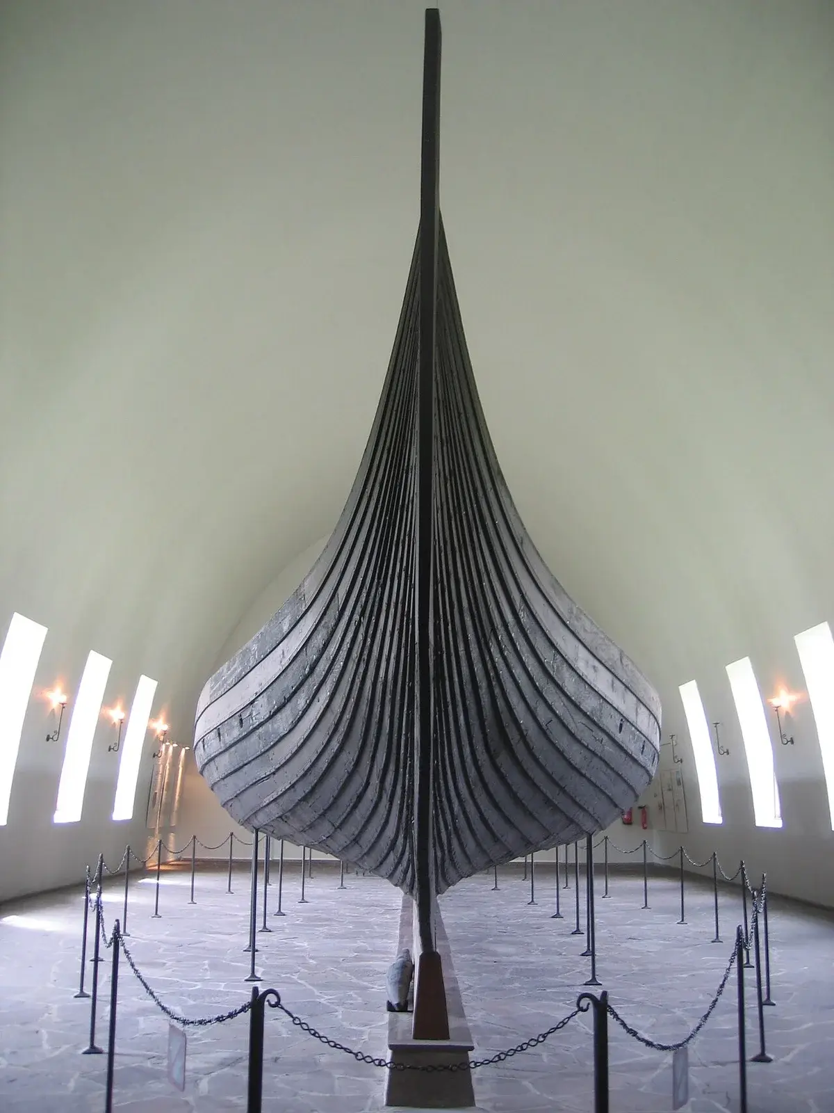 The Gokstad Viking ship displayed in a museum hall in Oslo.