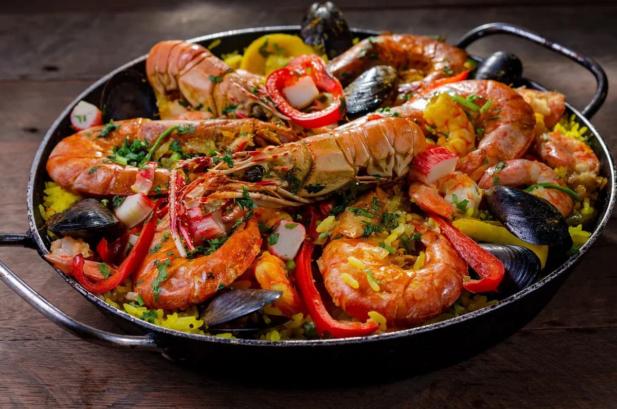 Seafood paella with prawns and mussels in a pan