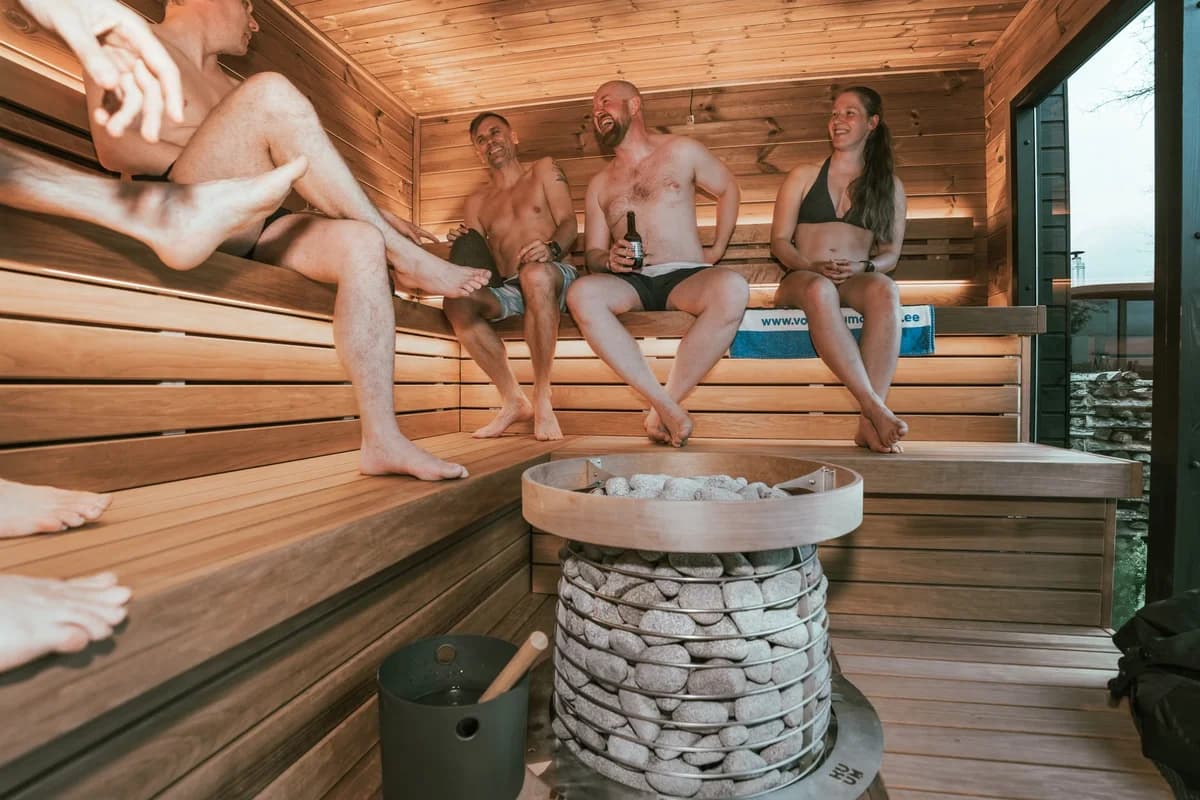 Adults relaxing together in a modern sauna.
