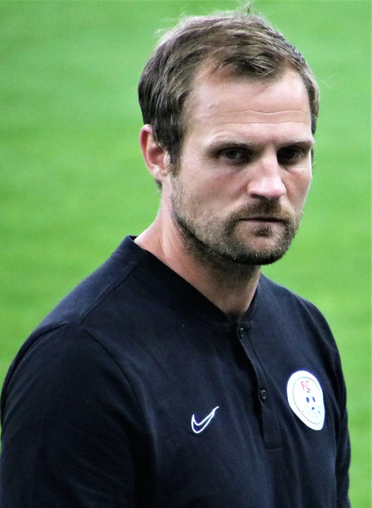 Bo Svensson standing on the sideline during a football match.
