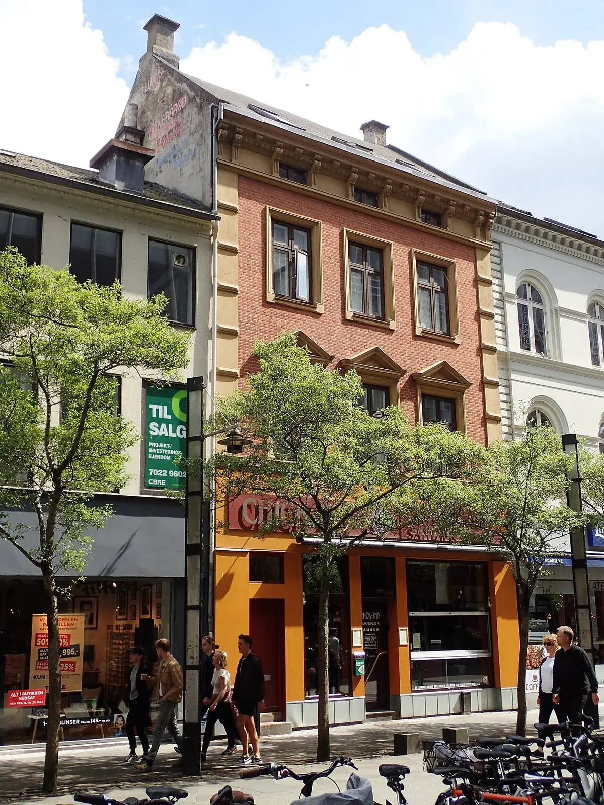 Immervad street in Aarhus with Restaurant Chick-Inn and pedestrians on a sunny spring day