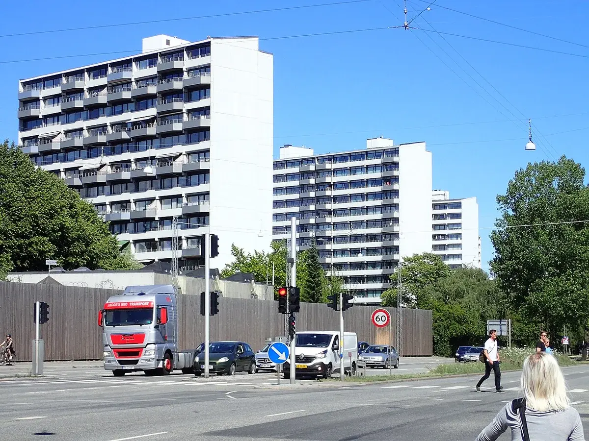 Busy street in Aarhus with high-rise apartment buildings in the background.