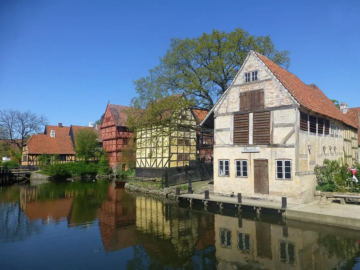Historic buildings beside a harbor in Den Gamle By, Denmark.