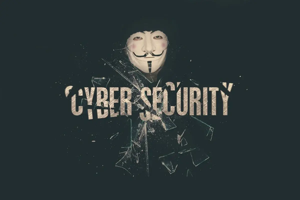 Masked figure with the words cyber security and shattered glass effects.
